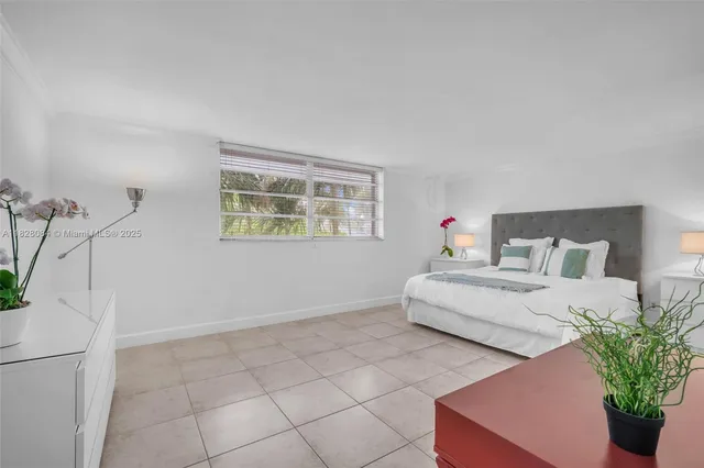 a bedroom with bed and window