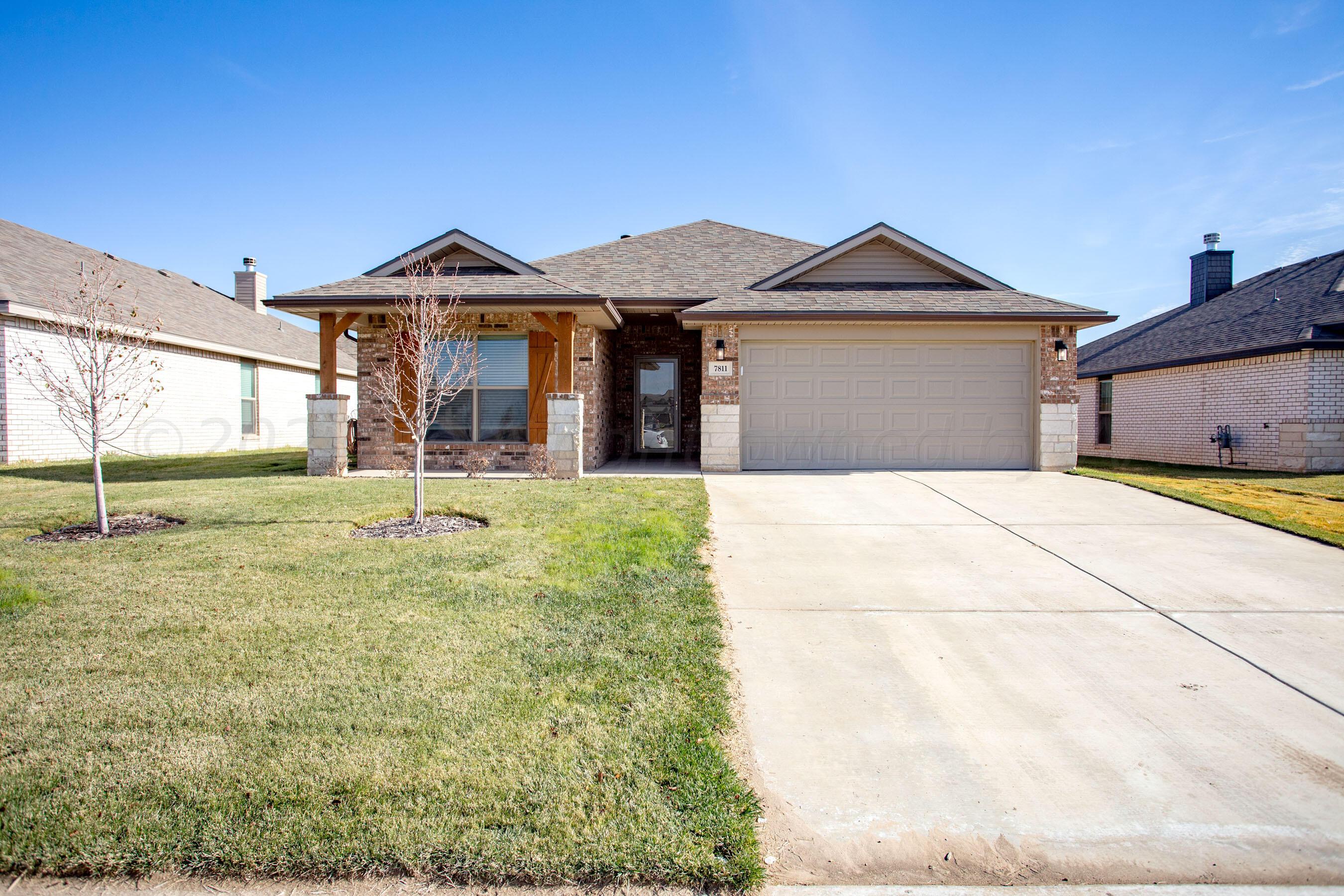 7811 Bellamy Drive Amarillo, TX 79119 - Photo 1 of 24 a front view of a house with garden