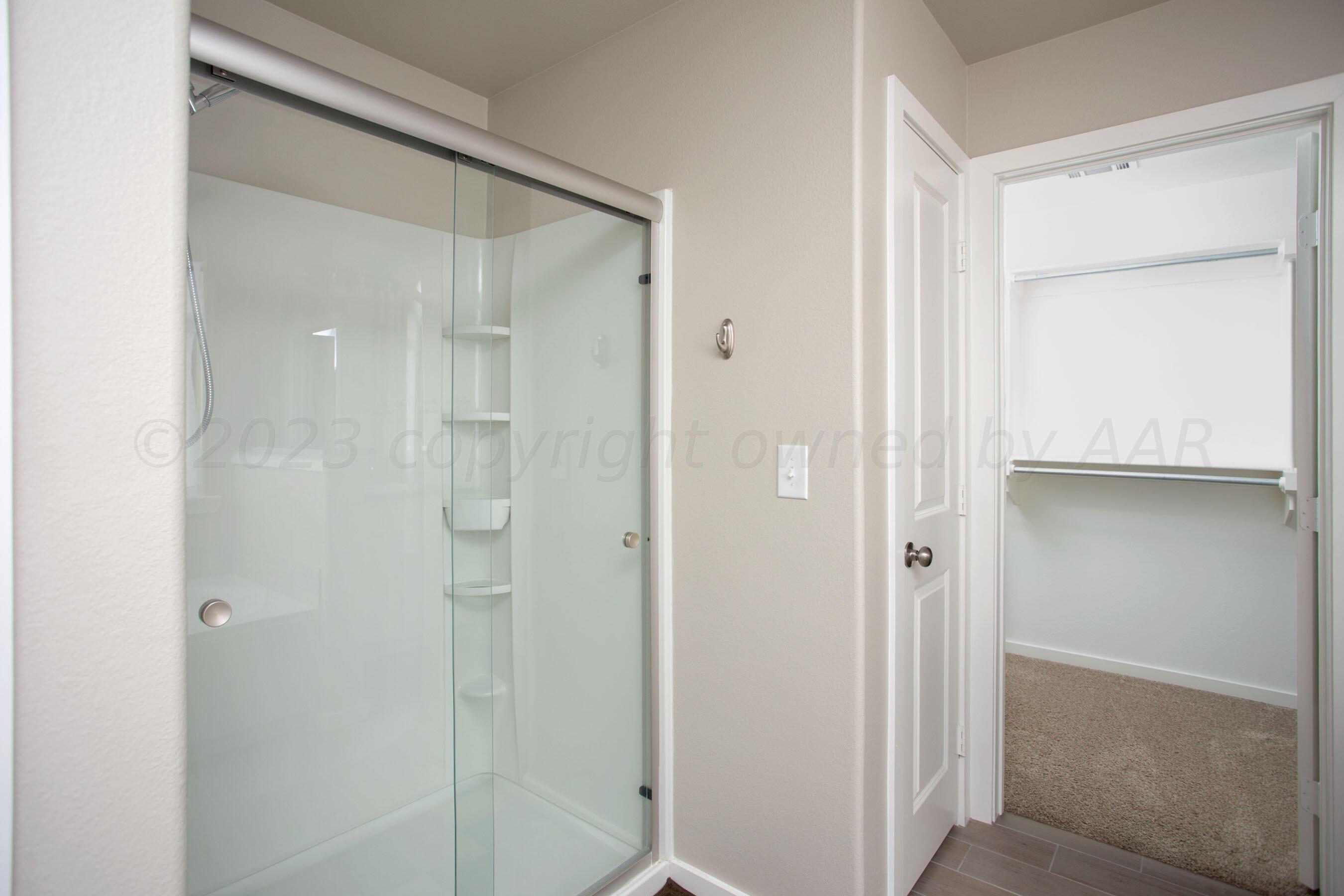 7811 Bellamy Drive Amarillo, TX 79119 - Photo 13 of 24 a bathroom with a glass shower door