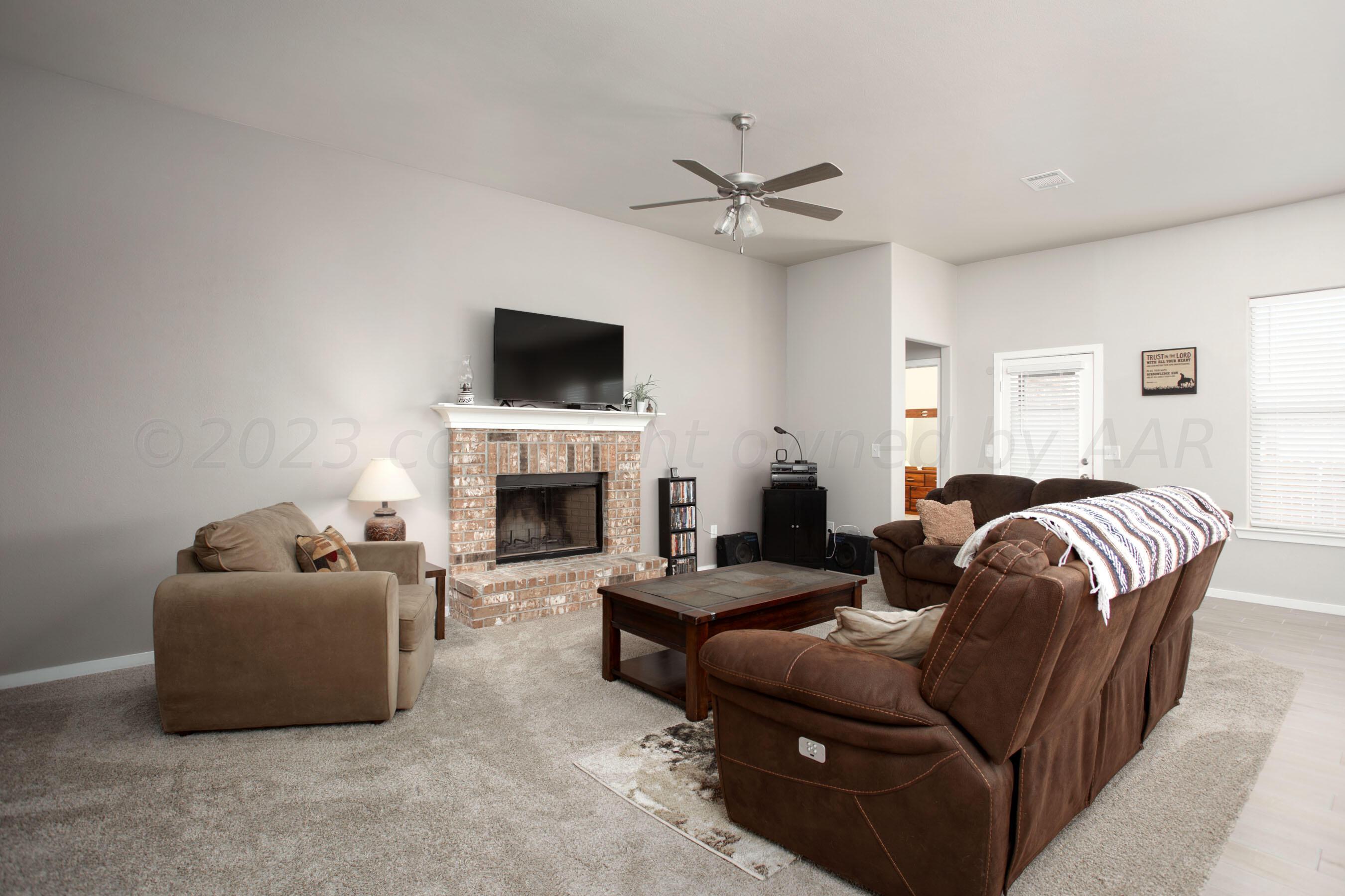 7811 Bellamy Drive Amarillo, TX 79119 - Photo 2 of 24 a living room with furniture a fireplace