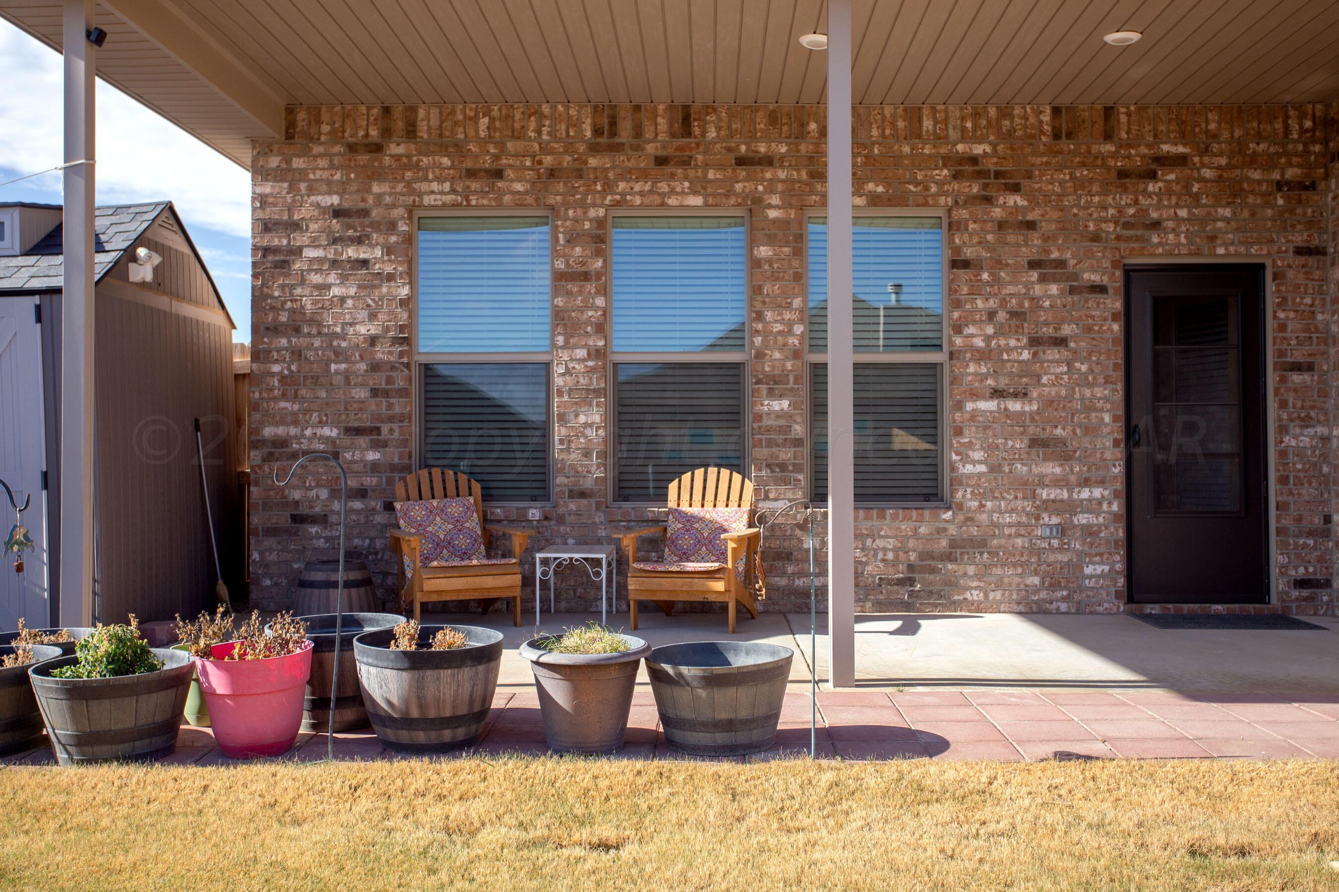 7811 Bellamy Drive Amarillo, TX 79119 - Photo 23 of 24 a view of a patio with couple of chairs and potted plants