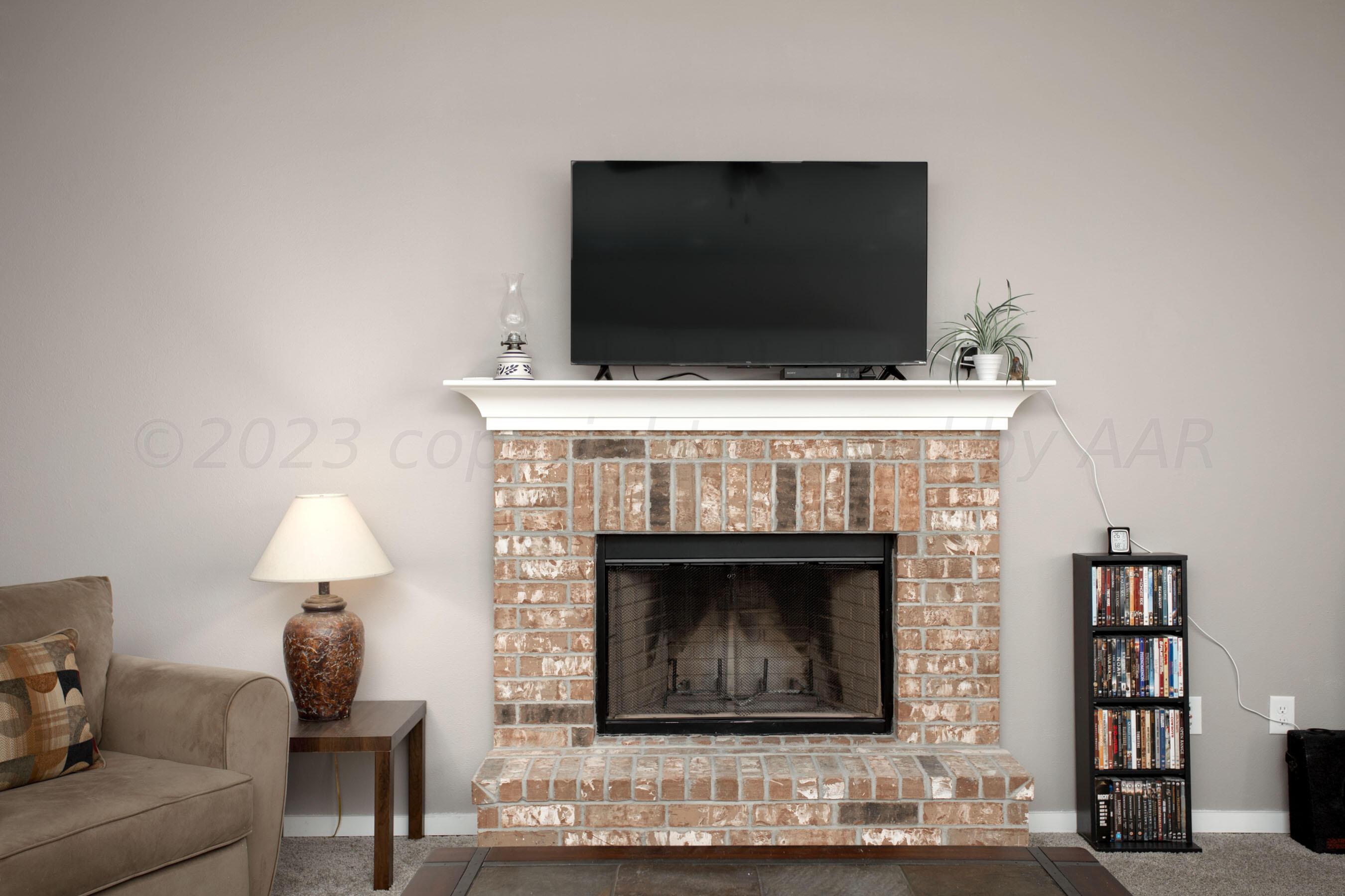 7811 Bellamy Drive Amarillo, TX 79119 - Photo 4 of 24 a living room with furniture and a fireplace