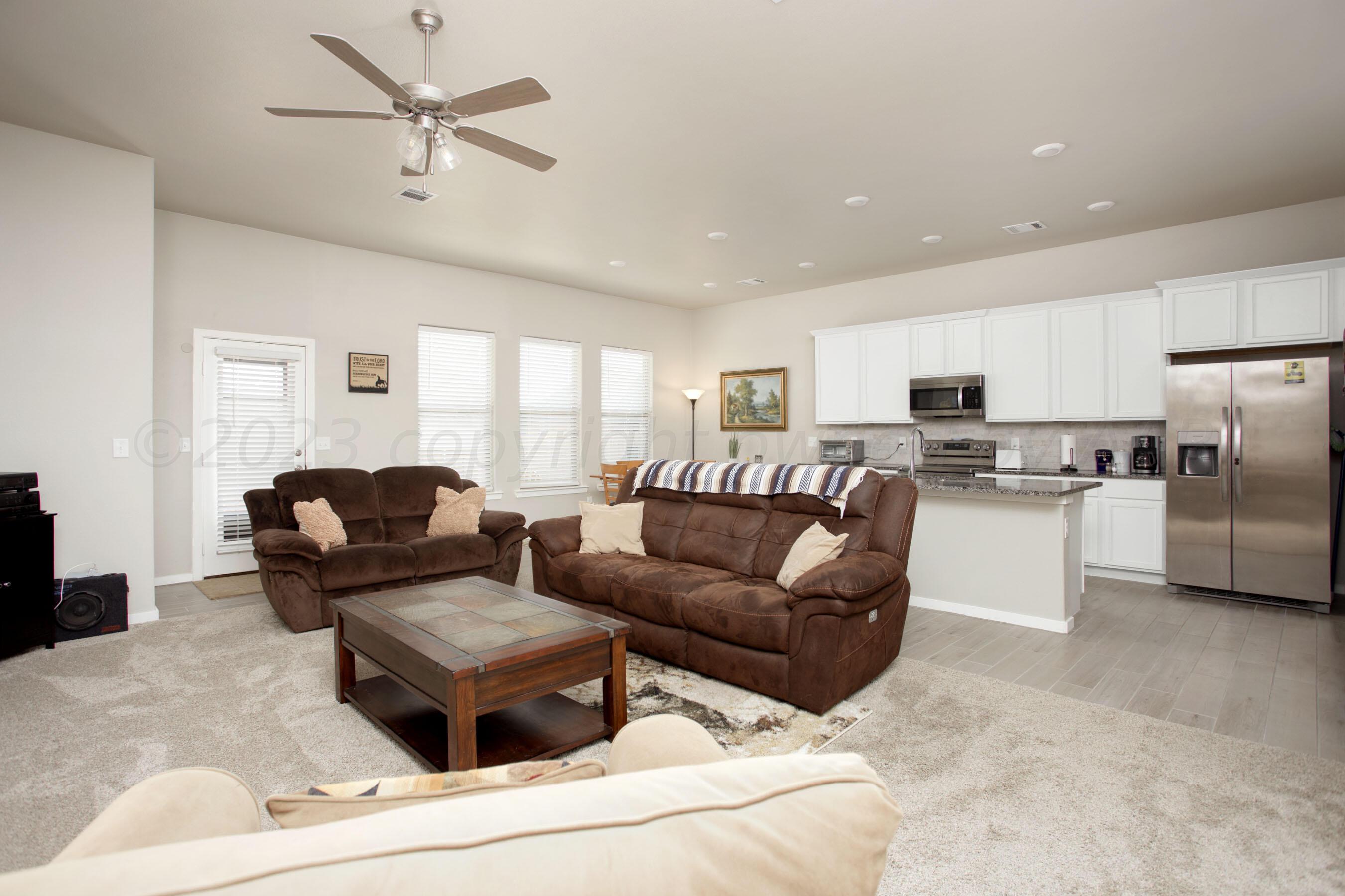 7811 Bellamy Drive Amarillo, TX 79119 - Photo 5 of 24 a living room with furniture and kitchen view
