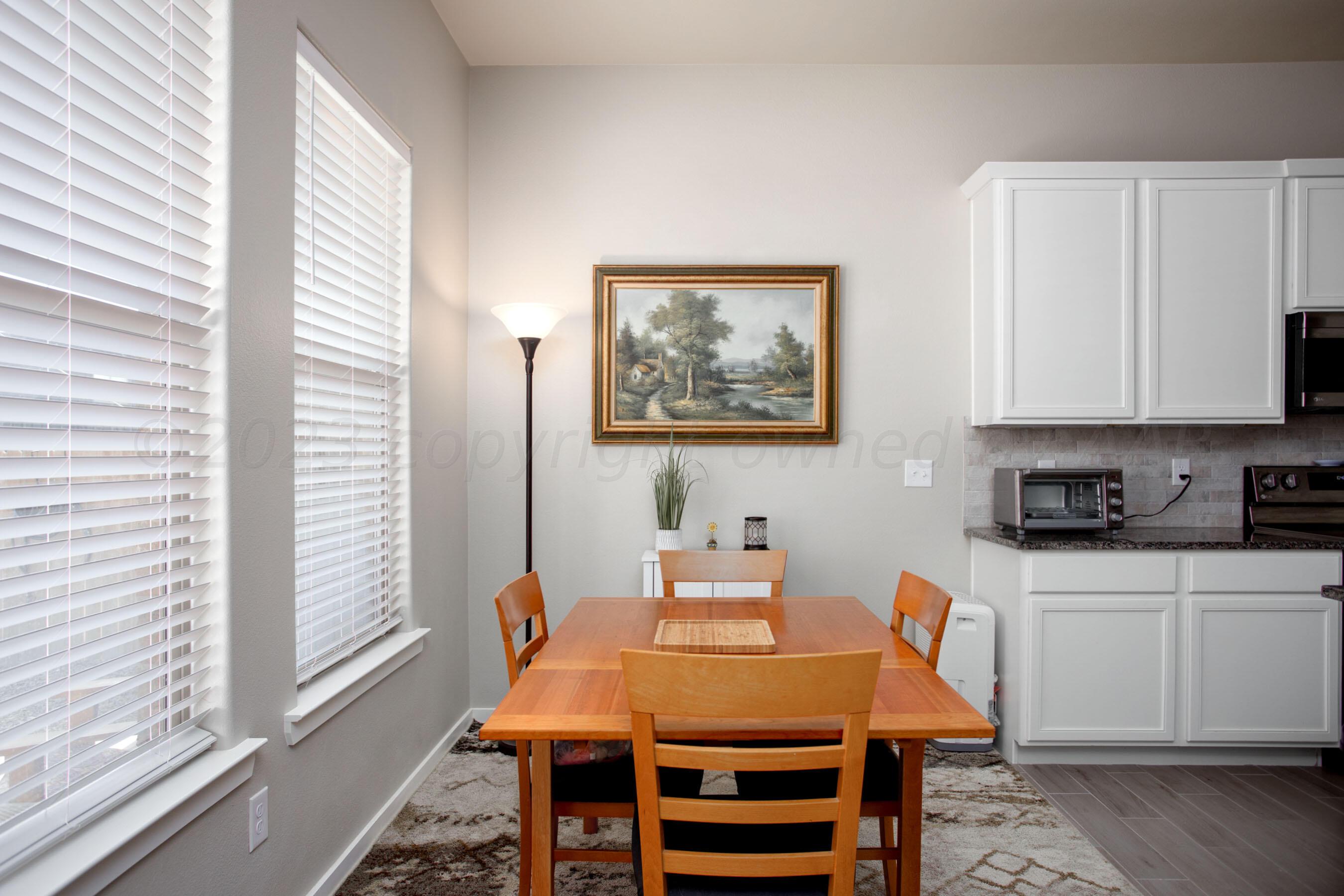 7811 Bellamy Drive Amarillo, TX 79119 - Photo 8 of 24 a dining room with a table chairs and a window