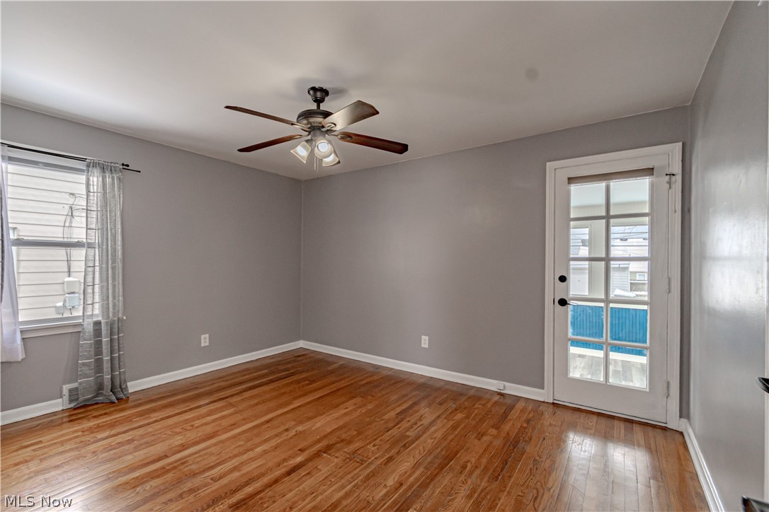 4157 Verona Road Cleveland, OH 44121 - Photo 12 of 26 Unfurnished room with light wood-type flooring, a ceiling fan, and healthy amount of natural light