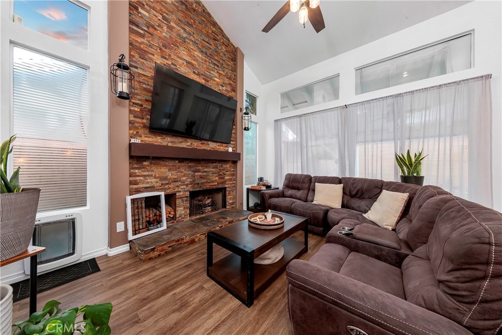 28630 Oak Valley Road Castaic, CA 91384 - Photo 11 of 54 a living room with furniture a flat screen tv and a fireplace