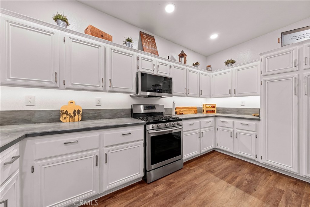28630 Oak Valley Road Castaic, CA 91384 - Photo 17 of 54 a kitchen with granite countertop white cabinets and white appliances