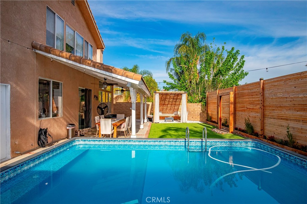 28630 Oak Valley Road Castaic, CA 91384 - Photo 43 of 54 a backyard of a house with barbeque oven table and chairs