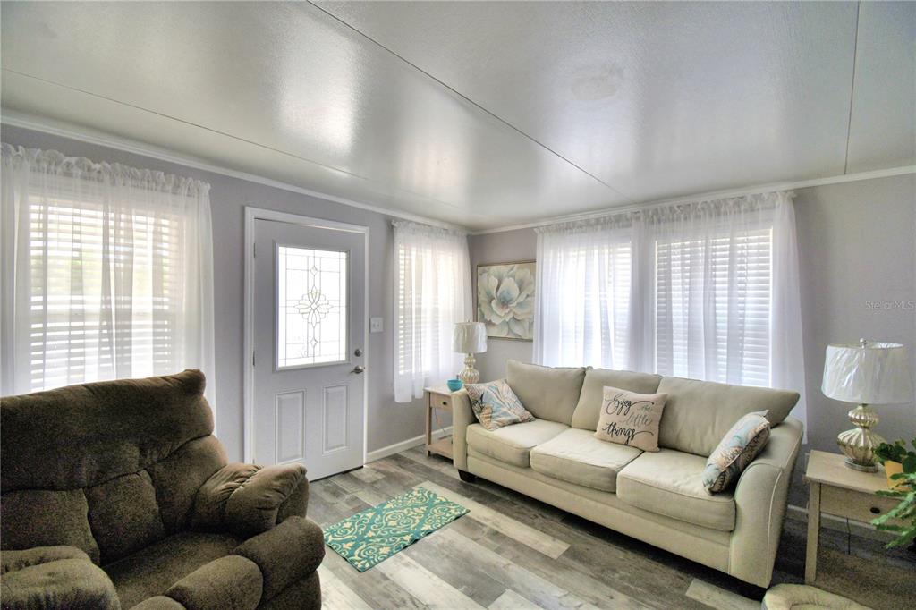 251 Patterson Road, Unit I58 Haines City, FL 33844 - Photo 11 of 52 a living room with furniture and a large window