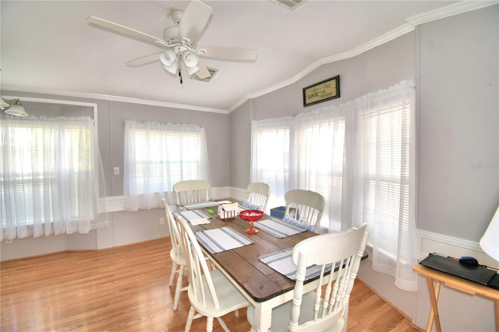 251 Patterson Road, Unit I58 Haines City, FL 33844 - Photo 13 of 52 a view of a dining room with furniture window and wooden floor