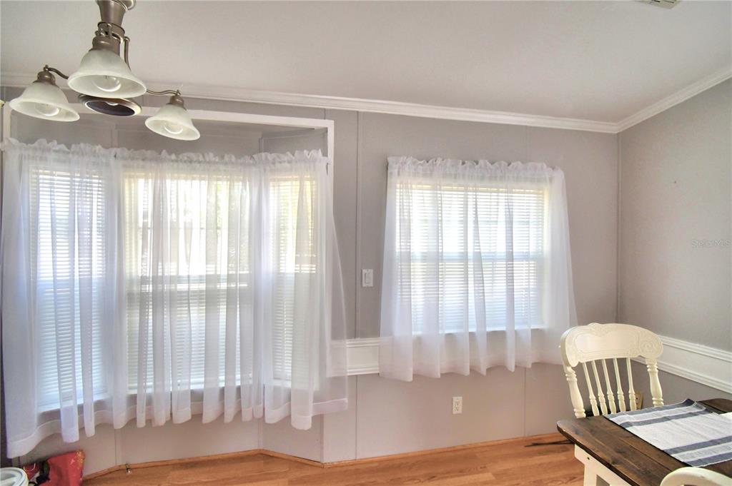 251 Patterson Road, Unit I58 Haines City, FL 33844 - Photo 16 of 52 a view of an empty room with wooden floor and a window