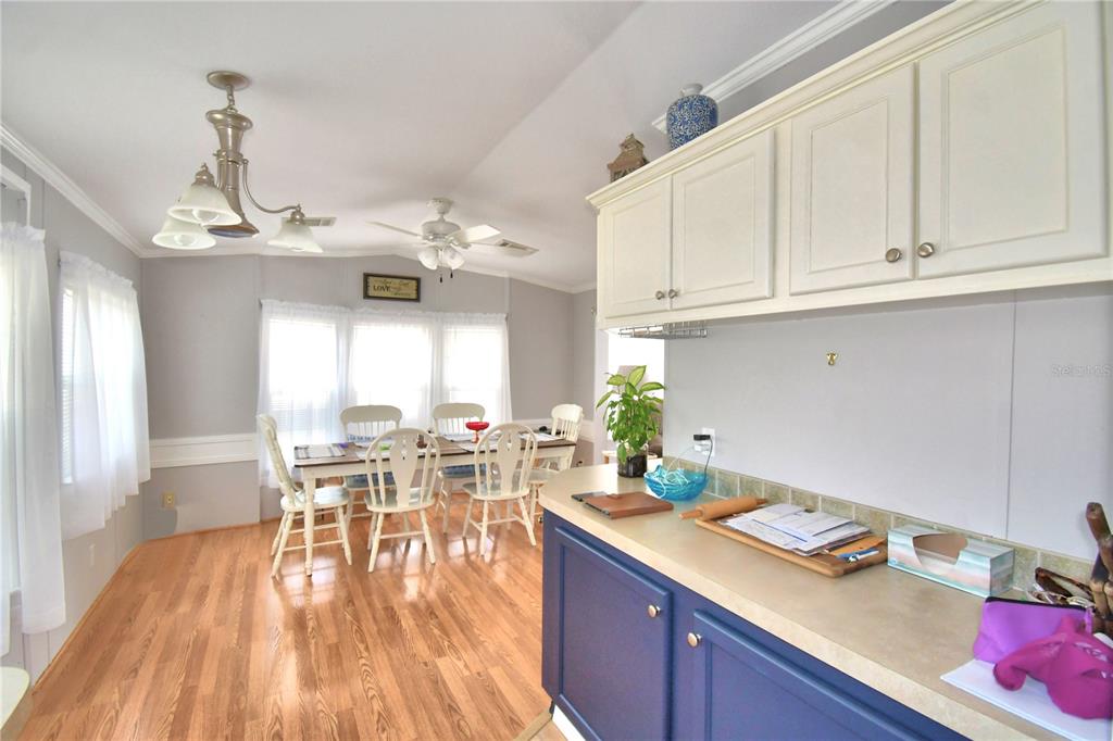 251 Patterson Road, Unit I58 Haines City, FL 33844 - Photo 18 of 52 a view of a dining room and livingroom with furniture wooden floor a chandelier
