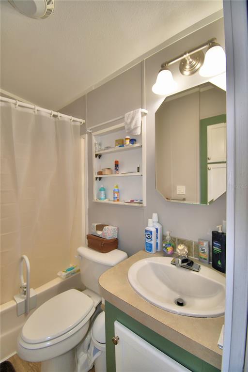 251 Patterson Road, Unit I58 Haines City, FL 33844 - Photo 23 of 52 a bathroom with a sink a toilet and shower curtain