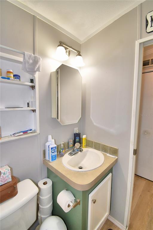251 Patterson Road, Unit I58 Haines City, FL 33844 - Photo 24 of 52 a bathroom with a sink toilet and a mirror