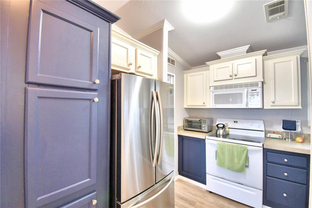 251 Patterson Road, Unit I58 Haines City, FL 33844 - Photo 25 of 52 a kitchen with stainless steel appliances granite countertop a refrigerator and a sink