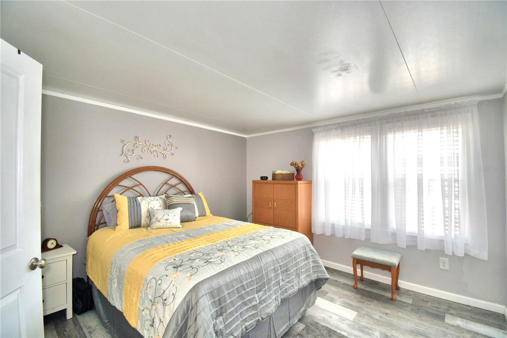 251 Patterson Road, Unit I58 Haines City, FL 33844 - Photo 26 of 52 a bedroom with a bed and a window