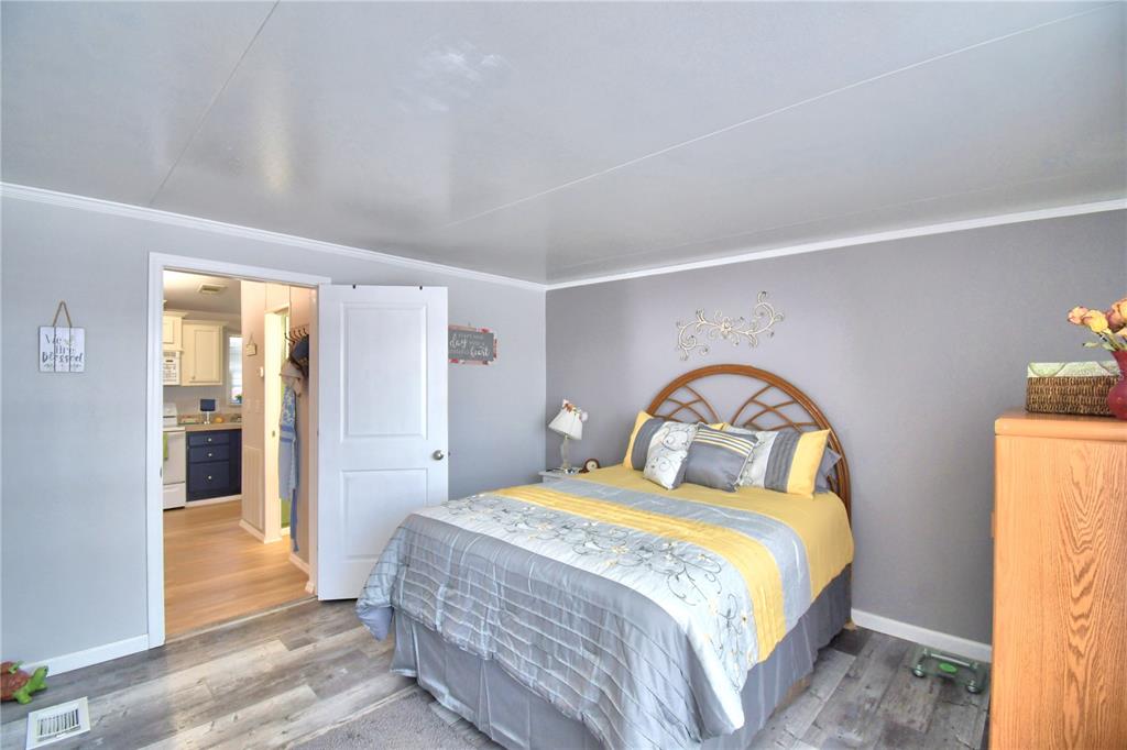 251 Patterson Road, Unit I58 Haines City, FL 33844 - Photo 27 of 52 a bedroom with a bed and a mirror