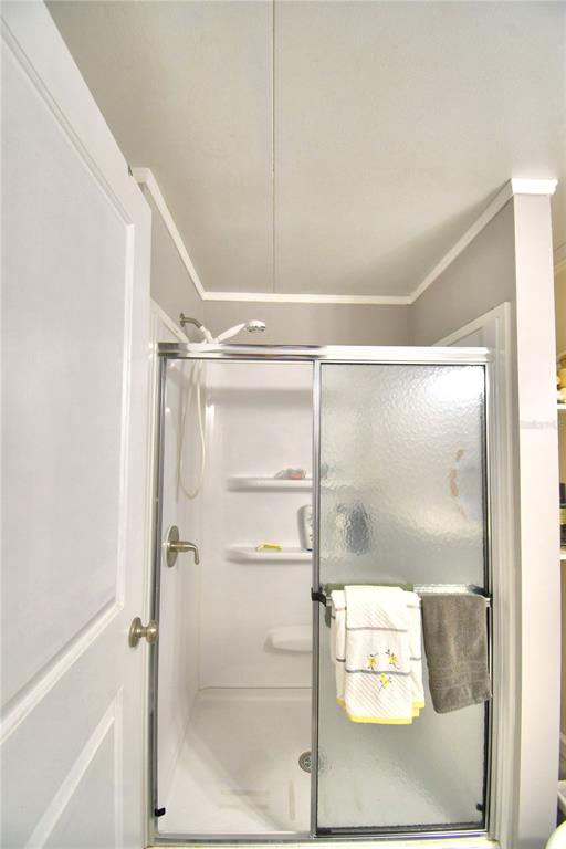 251 Patterson Road, Unit I58 Haines City, FL 33844 - Photo 34 of 52 a bathroom with a glass shower door