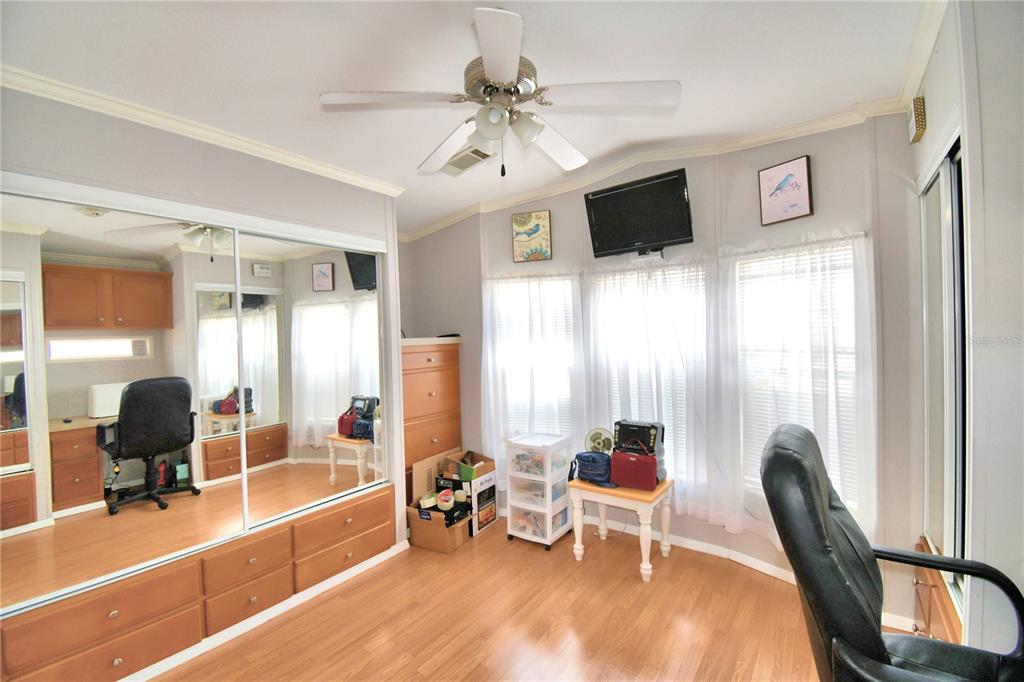 251 Patterson Road, Unit I58 Haines City, FL 33844 - Photo 35 of 52 a room with furniture a flat screen tv and a chandelier