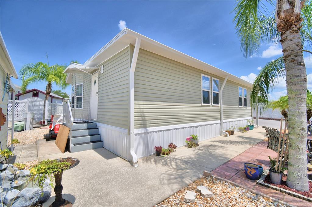 251 Patterson Road, Unit I58 Haines City, FL 33844 - Photo 42 of 52 a view of a chairs and table in the backyard