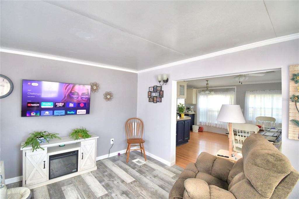 251 Patterson Road, Unit I58 Haines City, FL 33844 - Photo 10 of 52 a living room with furniture and a flat screen tv