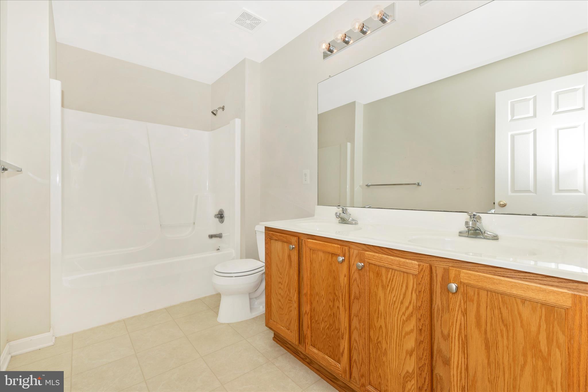102 Sunlight Drive Frederick, MD 21702 - Photo 42 of 65 a bathroom with a granite countertop sink toilet and shower