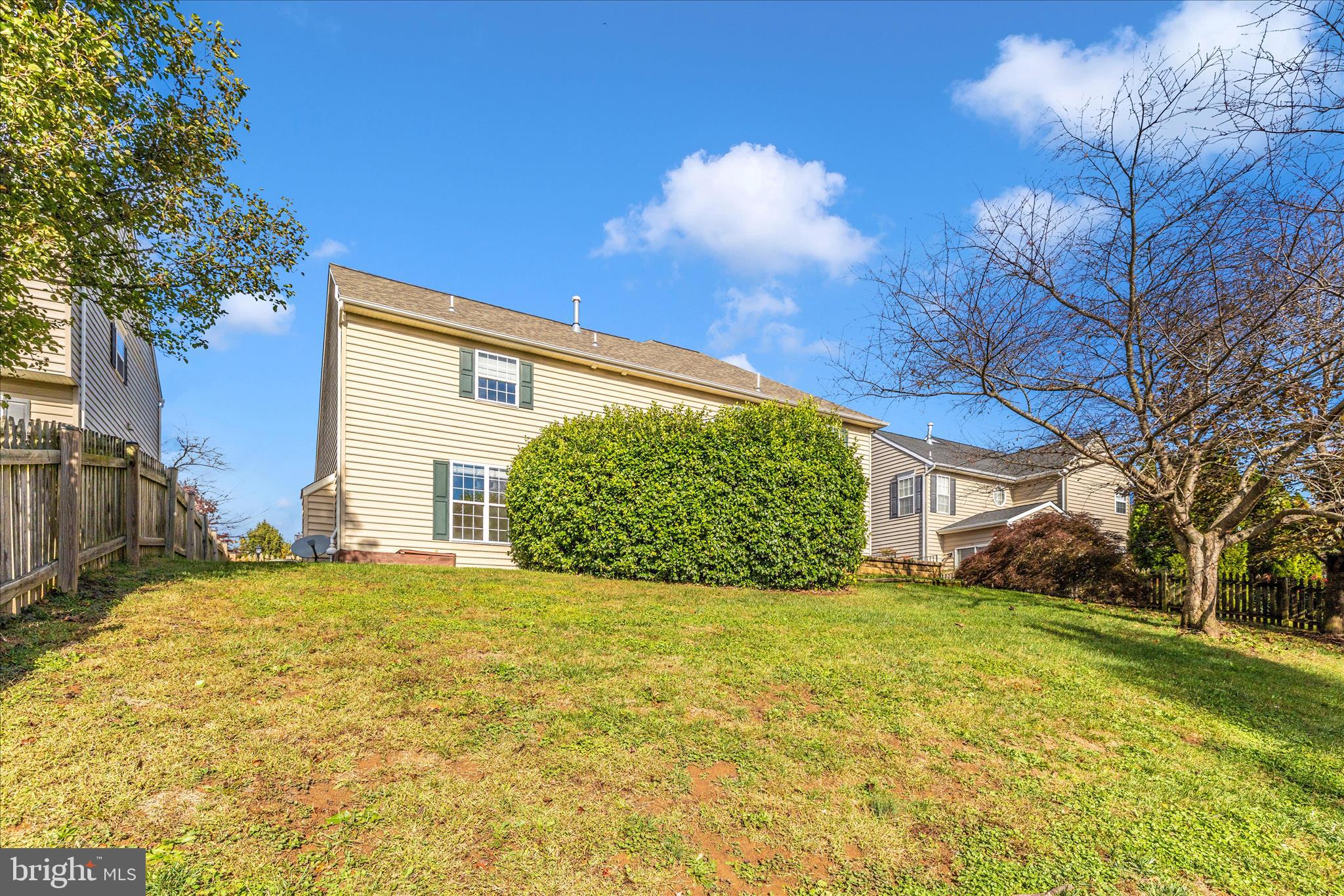 102 Sunlight Drive Frederick, MD 21702 - Photo 56 of 65 a view of yellow house with a big yard and large trees