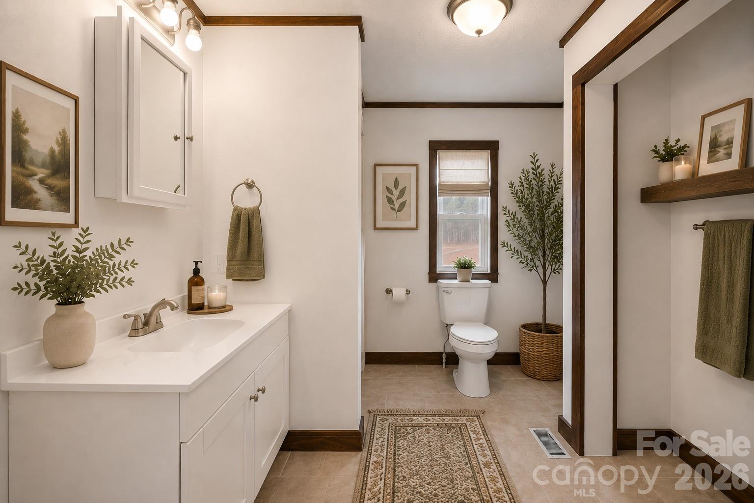 7400 Corn Hill Road Connelly Springs, NC 28612 - Photo 15 of 41 a bathroom with a toilet sink and mirror