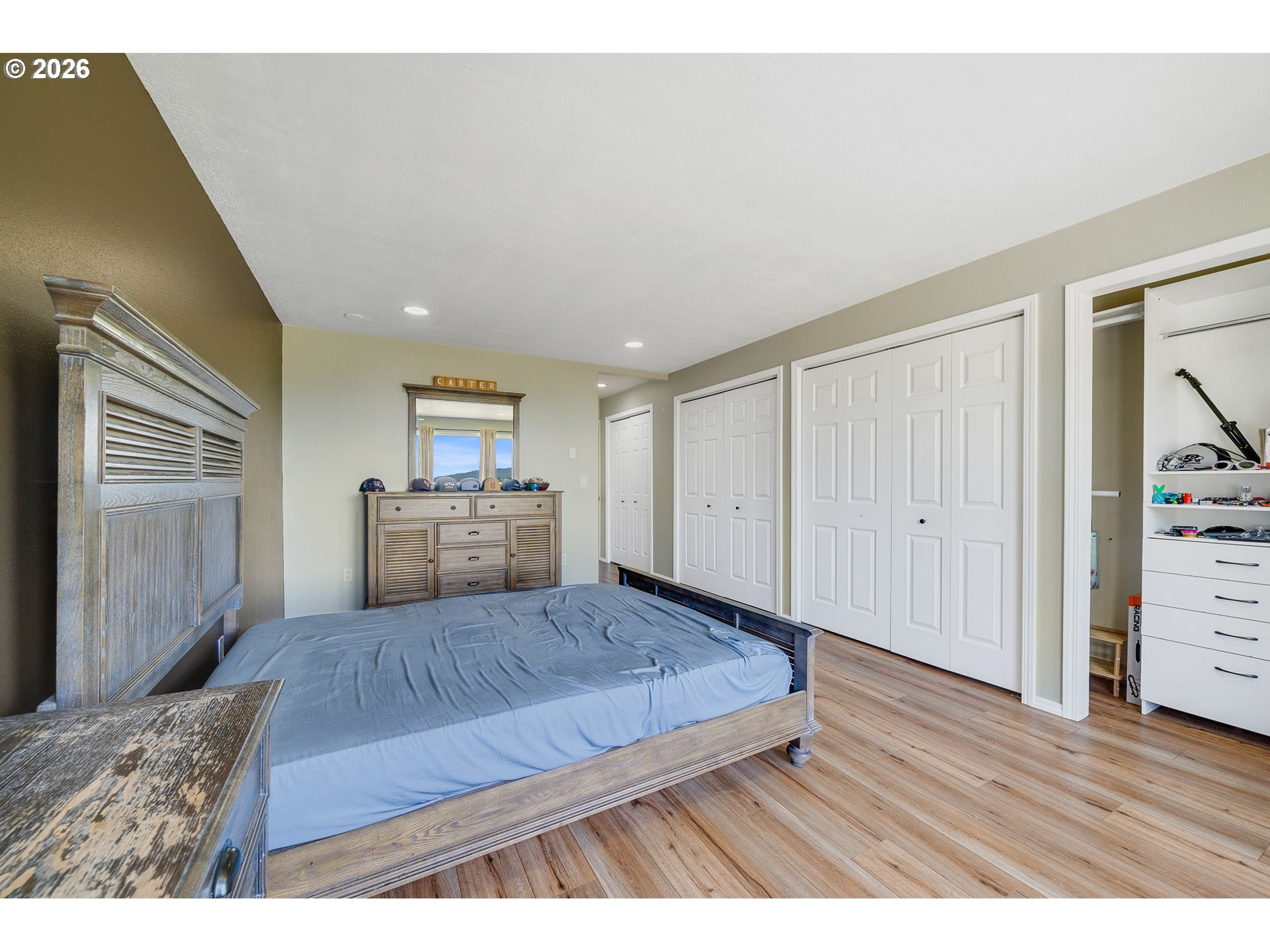 850 Hodgdon Road Tillamook, OR 97141 - Photo 15 of 43 a living room with a bed and dresser with wooden floor
