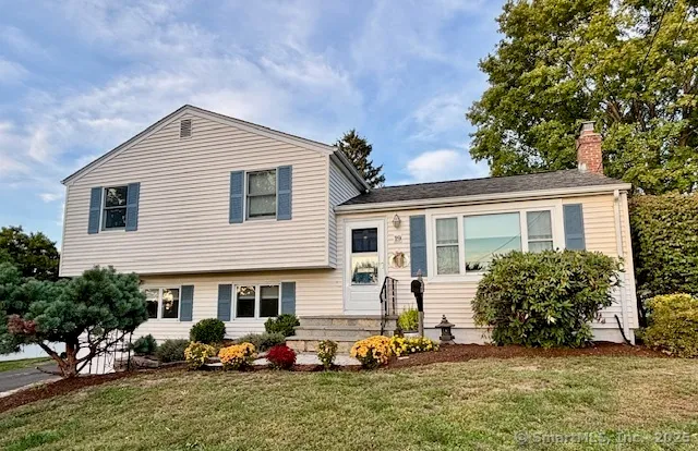 a front view of house with yard and outdoor seating