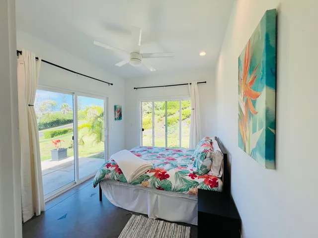 a bedroom with furniture and a large window