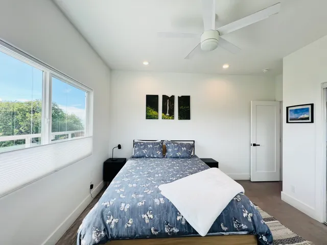 a bedroom with a large bed and a window