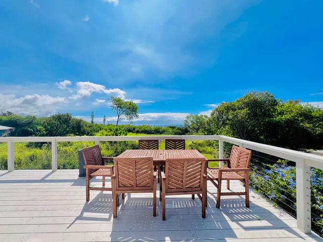a view of a patio with furniture and garden