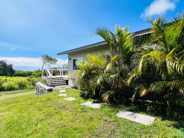 a view of a chair and table in the garden