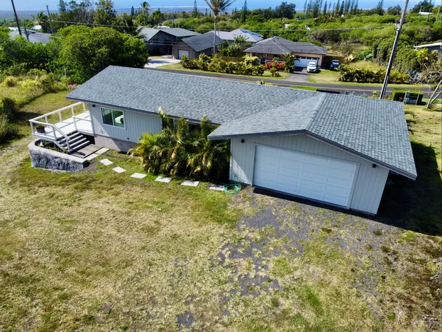an aerial view of a house with swimming pool and outdoor space
