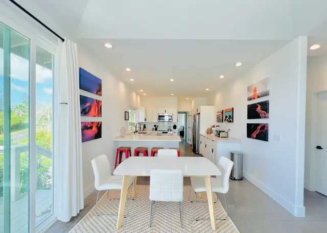a very nice looking dining room with kitchen island and a wooden floor