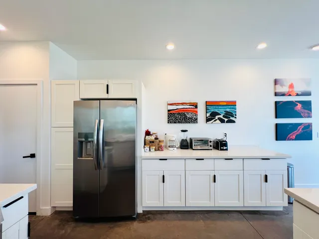 a kitchen with stainless steel appliances a refrigerator sink and cabinets