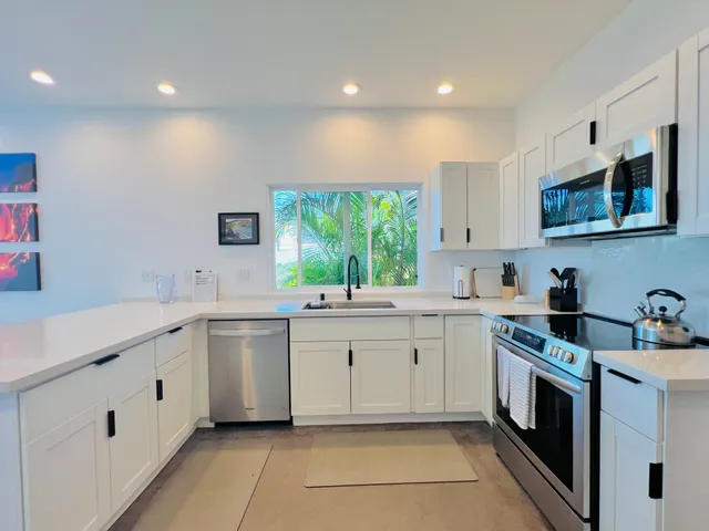 a kitchen with a sink stove and cabinets