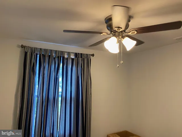 a view of a chandelier fan and fire place