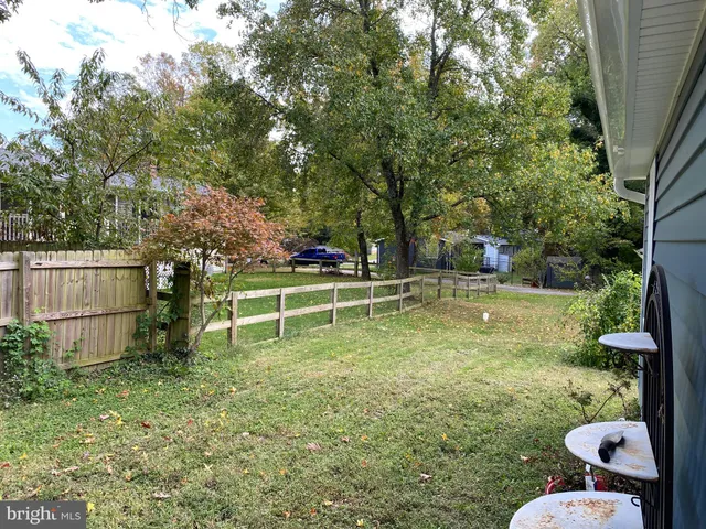 a view of a backyard with lawn chairs and a fire pit