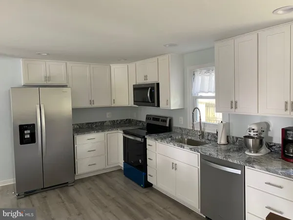 a kitchen with a sink stove and refrigerator