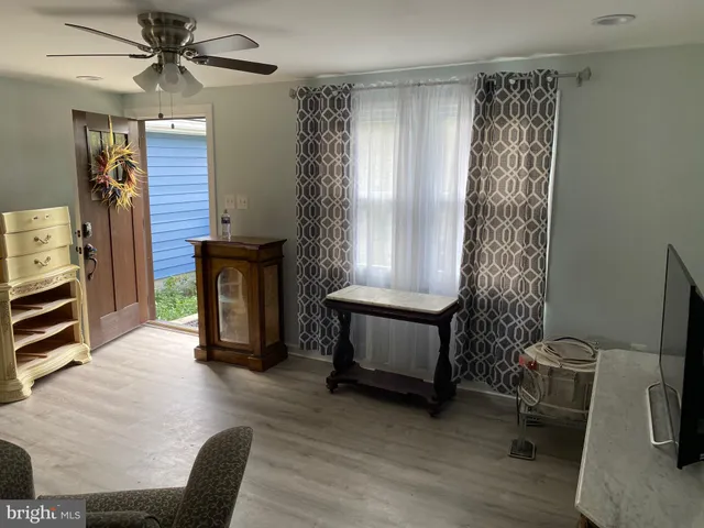 a view of a livingroom with furniture and a window