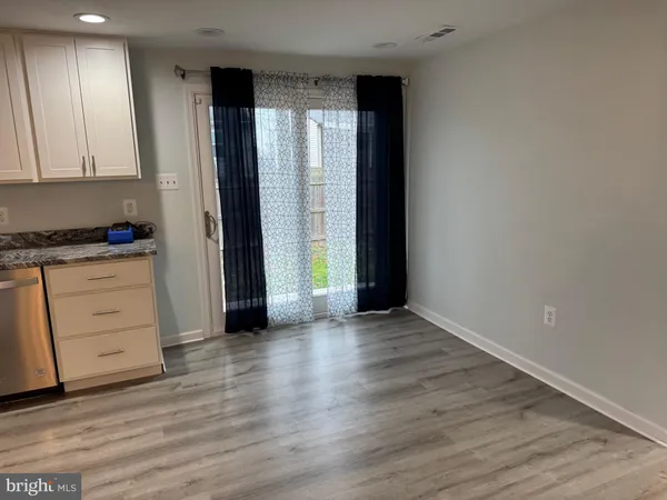 an empty room with closet and a window
