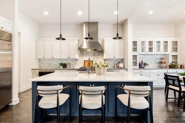 a kitchen with cabinets table and chairs