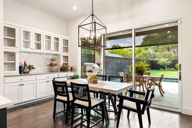 a dining room with furniture a chandelier and wooden floor