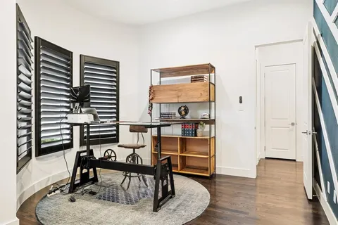 a dining room with furniture and wooden floor