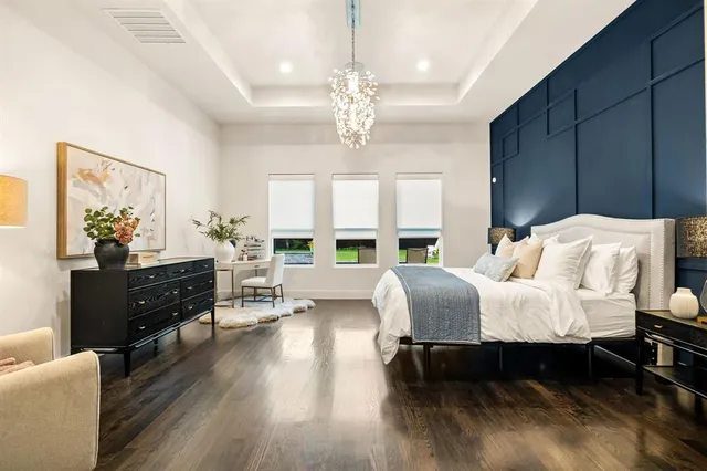 a bed room with furniture and a chandelier