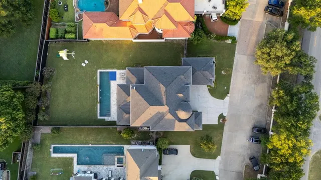 an aerial view of a house with a yard