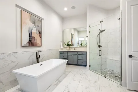 a bathroom with a double vanity sink mirror and shower