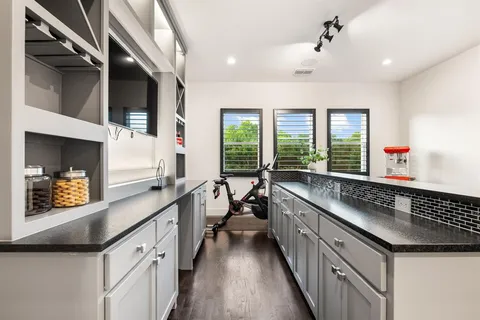 a kitchen with granite countertop a sink and a large window